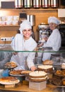 Cafe staff offering cakes for dessert Royalty Free Stock Photo