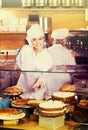 Cafe staff offering cakes Royalty Free Stock Photo