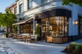 Cafe storefront with outdoor seating, modern urban setting, stone pavement.