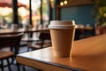 Cafe table with a paper coffee cup, perfect for takeout Royalty Free Stock Photo