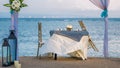 Cafe Table on a tropical sandy beach with sea on background, Nusa Dua, Bali Royalty Free Stock Photo