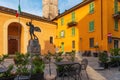 Cafe tables and chairs outside in old cozy street in medieval town square on Como lake in outdoor restaurant with nobody Royalty Free Stock Photo