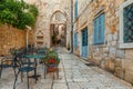 Cafe tables and chairs outside in old cozy street in the in old medieval town Hvar in outdoor restaurant with nobody Royalty Free Stock Photo