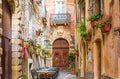 Cafe tables and chairs outside in old cozy street in the Positano town, Italy Royalty Free Stock Photo