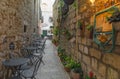 Cafe tables and chairs outside in old cozy street in Split, Croatia Royalty Free Stock Photo