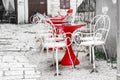 Cafe tables on the city street are waiting for visitors. red tables on the street. table and chairs, empty Royalty Free Stock Photo