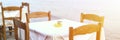 Cafe tables on the sea mediterranean embankment. selective focus. banner. flare. Royalty Free Stock Photo