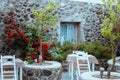 Cafe terrace in small European city at sunny summer day. Cafe with tables and chairs in an old street in Europe Royalty Free Stock Photo