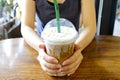 In the cafe, Woman holding cold coffee Royalty Free Stock Photo