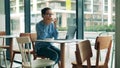 Cafe and a woman with a laptop drinking coffee