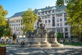 Cafes and shops surround the Vorosmarty Statue in Vorosmarty Square on a sunny day in Budapest, Hungary