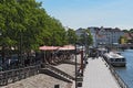 Cafes with tourists on the bank of the trave river in the old town of lubeck, germany Royalty Free Stock Photo