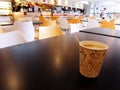 Cafeteria table with cup of hot coffee