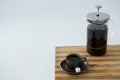 Cafetiere and a cup of black coffee on table Royalty Free Stock Photo