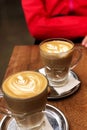 Caffe lattes with bokeh woman body Royalty Free Stock Photo