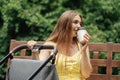 Caffeine and Breastfeeding. Young mom with coffee to go cup walk with newborn son. Mother walk with newborn baby in Royalty Free Stock Photo