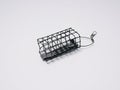 Cage feeder for feeder fishing on white background