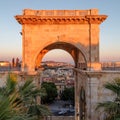 Cagliari, Sardinia, Italy. View of arch of Triumph and the city through the arch.