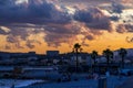 Cagnes-Sur-Mer, France 03.08.2020 Golden and dark clouds in the evening city near the beach. Heavenly dreamy fluffy