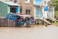 Cai Be, Vietnam. Boat and house of vietnamese people Royalty Free Stock Photo