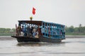 People cross river by local ferry boat at the Mekong delta in Cai Be, Vietnam.