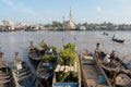 View to the boats floating on water with the church at the background in Cai Be, Vietnam.