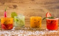 Caipirinha, Brazilian national cocktail made with cachaÃÂ§a, sugar cane liqueur and fruit on wooden background Royalty Free Stock Photo