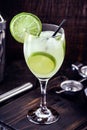 Caipirinha cocktail in glass on wooden table background. Copyspace, international caipirinha day, 13th September