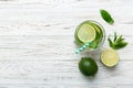 Caipirinha, Mojito cocktail, vodka or soda drink with lime, mint and straw on table background. Refreshing beverage with Royalty Free Stock Photo