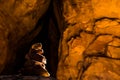 Cairn in dark tunnel through red sandstone slickrock in Moab Utah