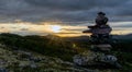 Cairn outdoors in nature during golden hour and sunset. Panoramic view. Royalty Free Stock Photo