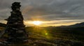 Cairn outdoors in nature during golden hour and sunset. Panoramic view. Royalty Free Stock Photo