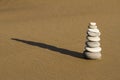 Cairn of rounded rocks on wet beach sand