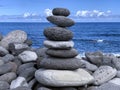 cairn on the shore against the blue sky close-up, balance Royalty Free Stock Photo