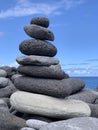 cairn on the shore against the blue sky close-up, balance Royalty Free Stock Photo