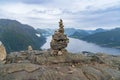 A cairn stack of stones and view from hiking Rampestreken and Nesaksla in Andalsnes Royalty Free Stock Photo