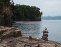 Cairn, stacked stones, on lake shore Royalty Free Stock Photo