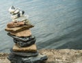 Cairn, stacked stones, on lake shore Royalty Free Stock Photo