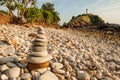 Cairn zen meditation, stones balance on stone beach, mountain light house blurred backgrounds. Lanta Island, Thailand Royalty Free Stock Photo