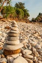 Cairn zen meditation, stones balance on stone beach, tropical trees and mountain blurred backgrounds. Lanta Island, Thailand Royalty Free Stock Photo