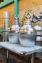 Metal drink urns for sale at an outdoor market