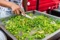 Street vendor cooking green peppers