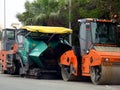 Cairo, Egypt, April 8 2023: Asphalt paver trucks and compactors, A paver (road paver finisher, asphalt finisher, road paving Royalty Free Stock Photo