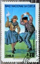 Old used postage stamp printed in Chile features the national Chilean dance of The Cueca