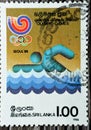 Old used Sri Lanka postage stamp features commemorative issue of the sport of swimming in the Olympic games Royalty Free Stock Photo