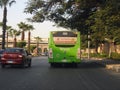 A public transport Egyptian green bus on a highway, selective focus of a public transportation one level touring bus