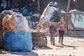 11/18/2018 Cairo, Egypt, children go to school on the street of a garbage town among a bunch of garbage