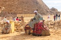 Bedouin sitting on his camel near Great Pyramids of Giza in Cairo, Egypt