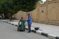 CAIRO/EGYPT - DECEMBER 06, 2018: cleaner with a trolley and a basket with garbage