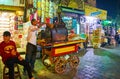 CAIRO, EGYPT - DECEMBER 21, 2017: The street seller of sweet potato cooks batata in oven, standing on his food cart in Al Muizz Royalty Free Stock Photo